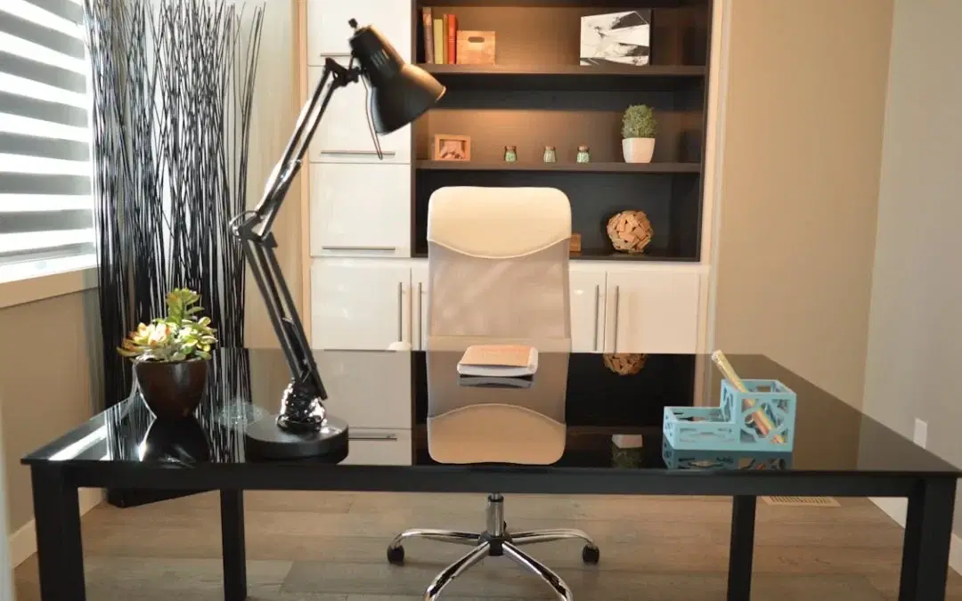 Modern home office with a black desk and white chair