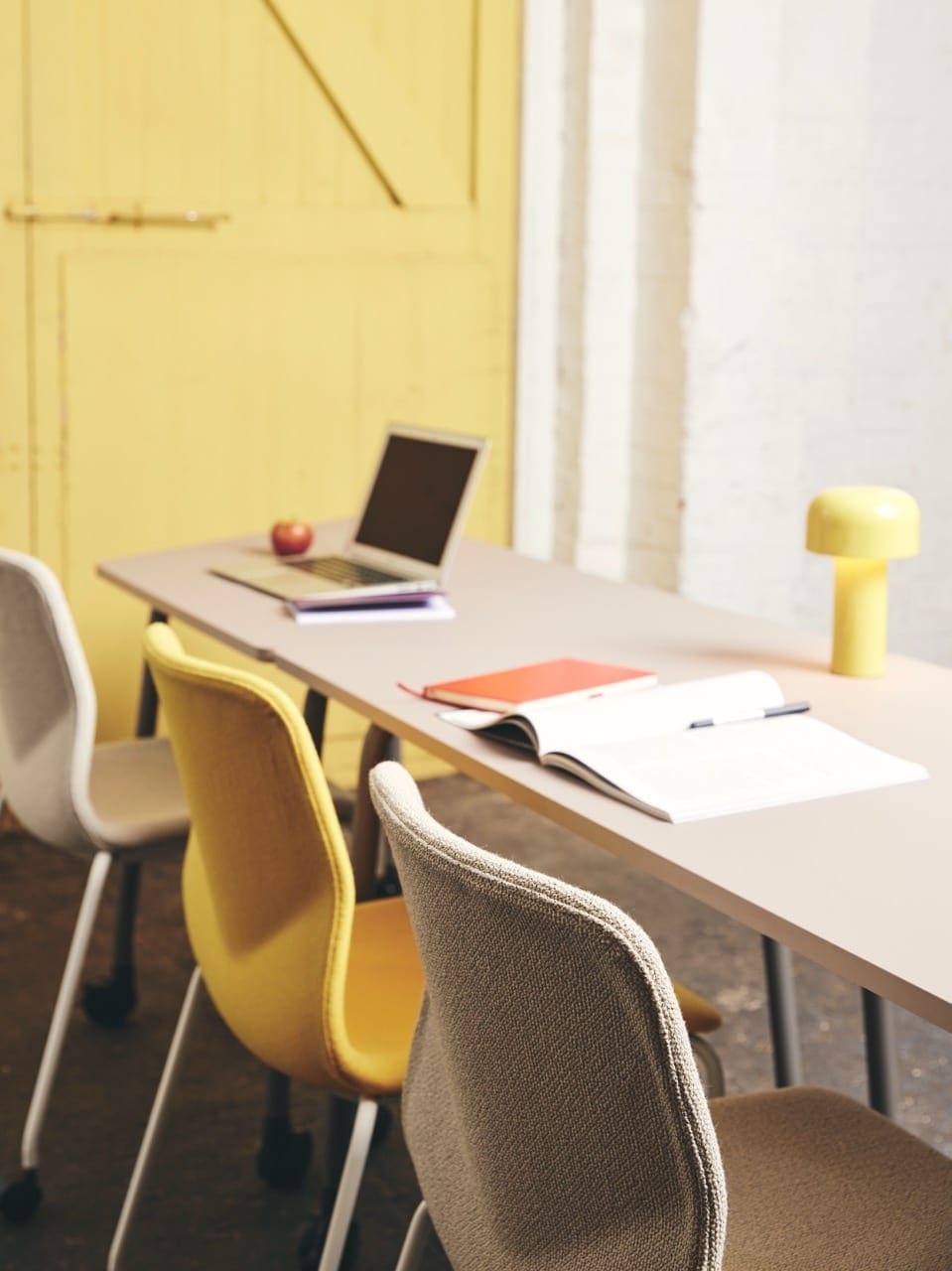 Yellow chairs at long table